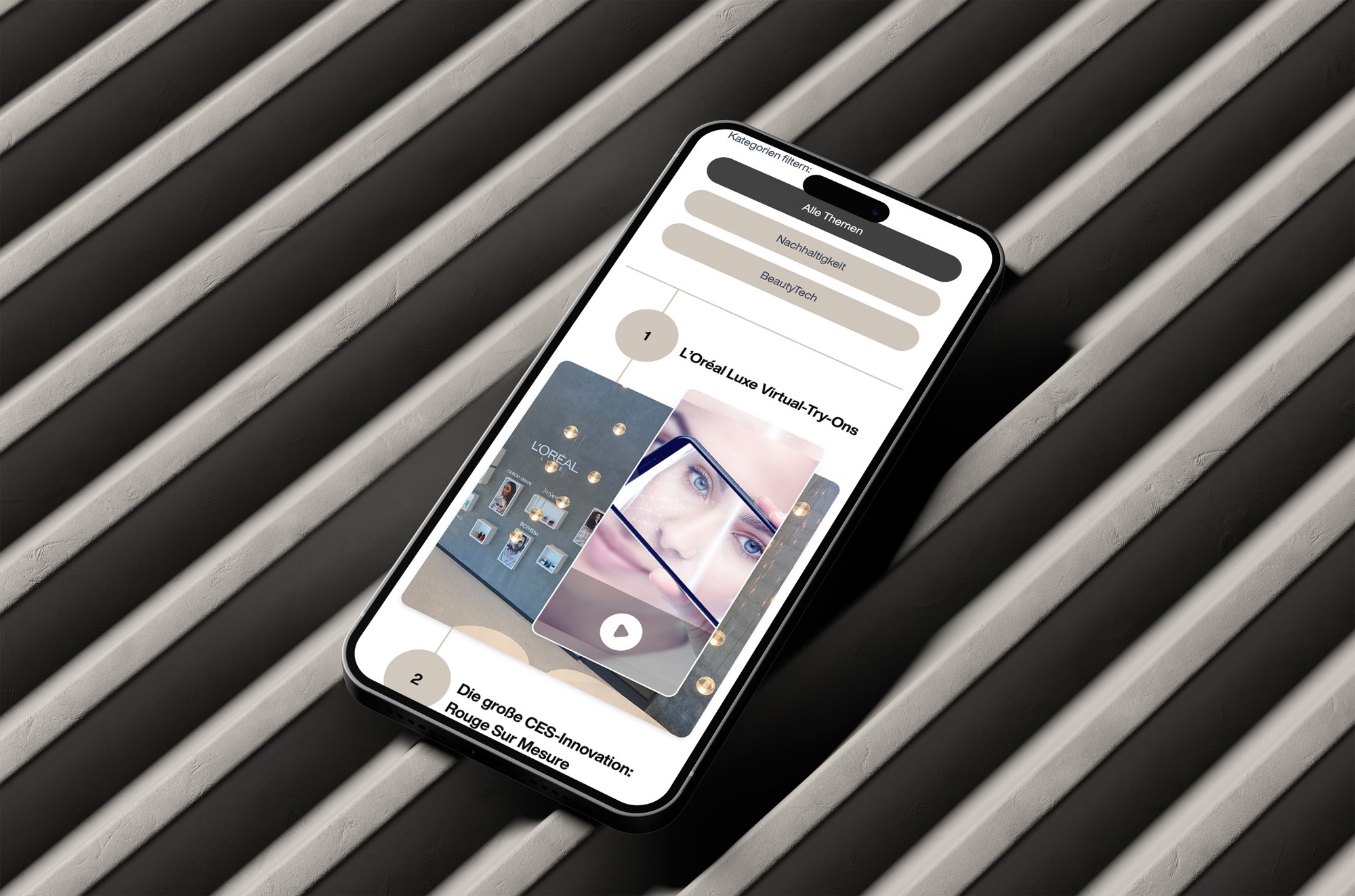 Smartphone-Mockup der L’Oréal Experience Day Microsite mit Themenfiltern und Videoinhalten